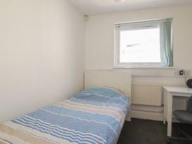 A bedroom with a bed and a desk at Newseal House
