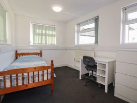 A bedroom with a bed and desk at Newseal House