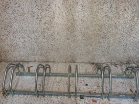 A bicycle rack mounted against a wall at Newseal House