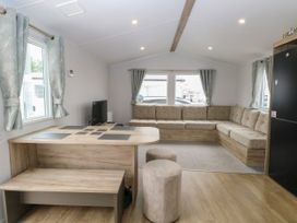 A living room with a sofa and coffee table at Haven Seashore, Ellerton Willerby Xtra, Great Yarmouth