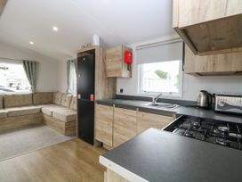 A kitchen with a sitting area and appliances at Haven Seashore, Ellerton Willerby Xtra, Great Yarmouth