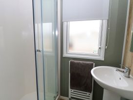 A bathroom with a shower and sink at Haven Seashore, Ellerton Willerby Xtra, Great Yarmouth
