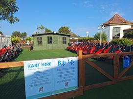 An outdoor kart hire area with go-karts and a shed at Haven Seashore, Ellerton Willerby Xtra, Great Yarmouth