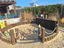 A sand play area enclosed with wooden posts and ropes at Haven Seashore, Great Yarmouth