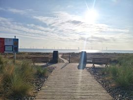 A pathway leading to the beach with benches and a signboard at Haven Seashore, Ellerton Willerby Xtra, Great Yarmouth