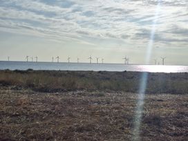 A view of wind turbines over the ocean at Haven Seashore, Ellerton Willerby Xtra in Great Yarmouth