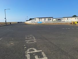A view of a road with caravans and a fence at Haven Seashore, Great Yarmouth