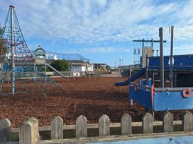 A playground with a climbing frame, slide, and swings at Haven Seashore, Ellerton Willerby Xtra Great Yarmouth