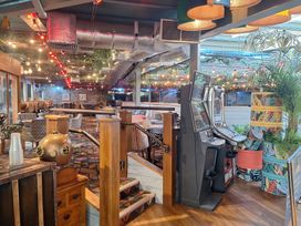 A dining room with slot machines and tables at Haven Seashore, Ellerton Willerby Xtra, Great Yarmouth