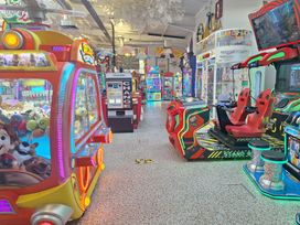 An arcade filled with various gaming machines at Haven Seashore, Ellerton Willerby Xtra, Great Yarmouth