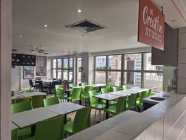 A dining room with tables and chairs at The Creative Studio in Great Yarmouth