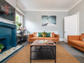 A living room with a sofa and television at 59 Garfield Road, Scarborough
