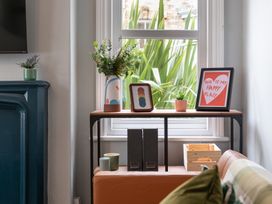 A shelf with plants and decorative items at 59 Garfield Road in Scarborough