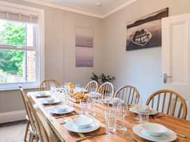 A dining room with a table set for a meal at 59 Garfield Road Scarborough