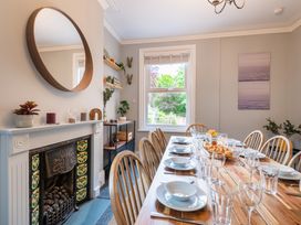 A dining room with a table set for a meal at 59 Garfield Road Scarborough