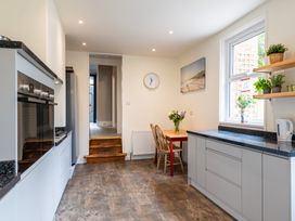 A kitchen with a dining table and chairs at 59 Garfield Road, Scarborough