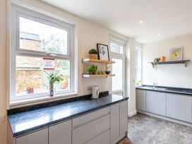 A kitchen with large windows and a countertop with plants at 59 Garfield Road in Scarborough