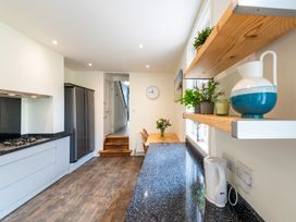A kitchen with wooden shelves and a refrigerator at 59 Garfield Road Scarborough