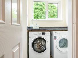 A laundry room with washing machine and tumble dryer at 59 Garfield Road Scarborough