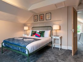 A bedroom with a bed, side tables, and wall art at 59 Garfield Road in Scarborough
