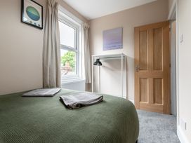 A bedroom with a bed and towels on top at 59 Garfield Road in Scarborough