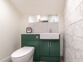 A bathroom with a toilet and sink at 59 Garfield Road Scarborough