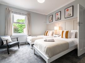 A bedroom with two beds and a chair at 59 Garfield Road in Scarborough