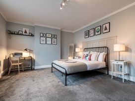 A bedroom with a bed and desk at 59 Garfield Road Scarborough