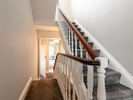 A hallway with stairs and a door at 59 Garfield Road Scarborough
