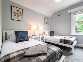 A bedroom with two beds and a window at 59 Garfield Road in Scarborough