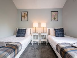 A bedroom with two single beds and nightstands at 59 Garfield Road, Scarborough