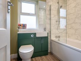 A bathroom with a sink, toilet, and bathtub at 59 Garfield Road in Scarborough