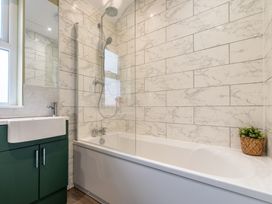 A bathroom with a bath tub and shower at 59 Garfield Road in Scarborough