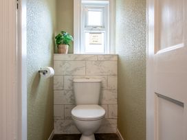 A bathroom with a toilet and a window at 59 Garfield Road in Scarborough