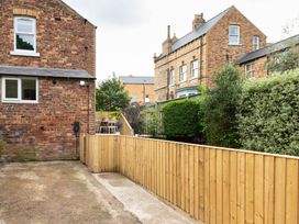 A garden with a wooden fence and seating area at 59 Garfield Road Scarborough