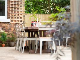 An outdoor dining area with a wooden table and chairs at 59 Garfield Road, Scarborough