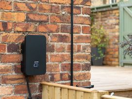 A charging station mounted on a brick wall at 59 Garfield Road, Scarborough