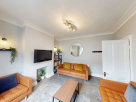 A living room with a sofa and coffee table at 44 Norwood Street Scarborough