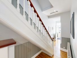 A hallway with a staircase and door at 44 Norwood Street Scarborough