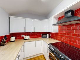 A kitchen with a stove and microwave at 44 Norwood Street Scarborough