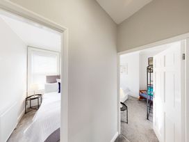 A view into two bedrooms with beds and furniture at 44 Norwood Street Scarborough