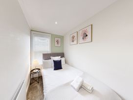 A bedroom with a bed and wall art at 44 Norwood Street Scarborough