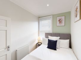 A bedroom with a bed and a lamp at 44 Norwood Street Scarborough
