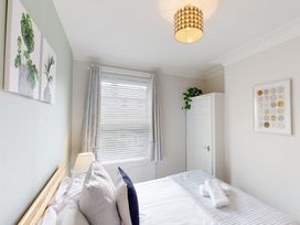 A bedroom with a bed and wardrobe at 44 Norwood Street in Scarborough