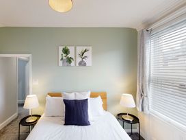 A bedroom with a bed and lamps at 44 Norwood Street Scarborough