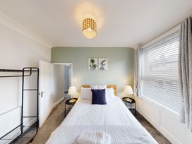A bedroom with a bed and lamps at 44 Norwood Street, Scarborough
