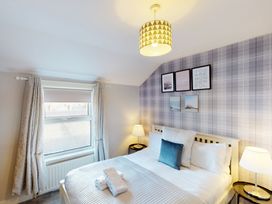 A bedroom with a bed and window at 44 Norwood Street in Scarborough