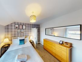 A bedroom with a bed and dresser at 44 Norwood Street, Scarborough