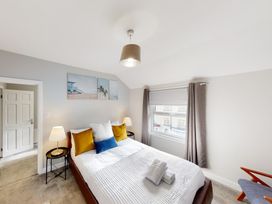A bedroom with a bed and bedside tables at 44 Norwood Street in Scarborough