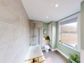 A bathroom with a bathtub and shower at 44 Norwood Street Scarborough